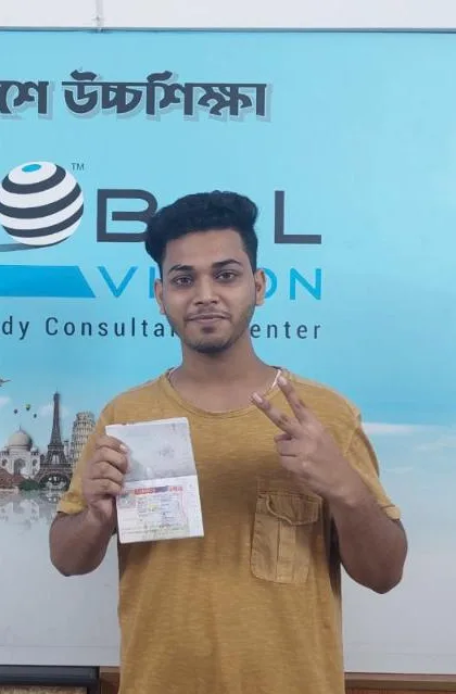 A Global Vision student holding a visa at the office
