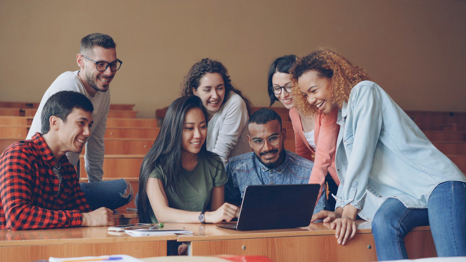 International students gathered around a laptop